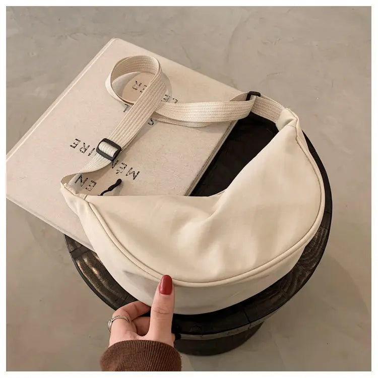 Women's bag - A round-shaped nylon bag with a cross-body strap, suitable for traveling, going to school or shopping.