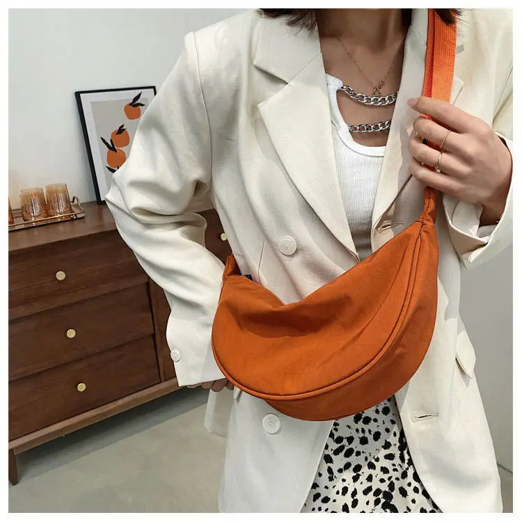 Women's bag - A round-shaped nylon bag with a cross-body strap, suitable for traveling, going to school or shopping.